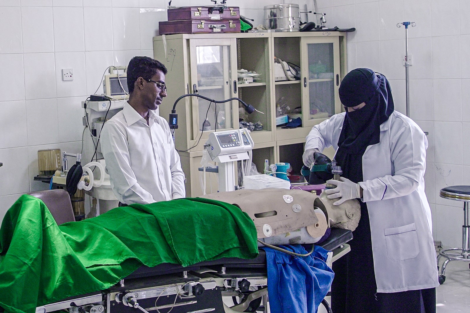 A dignified man in a white coat stands confidently, embodying professionalism and expertise in his field.