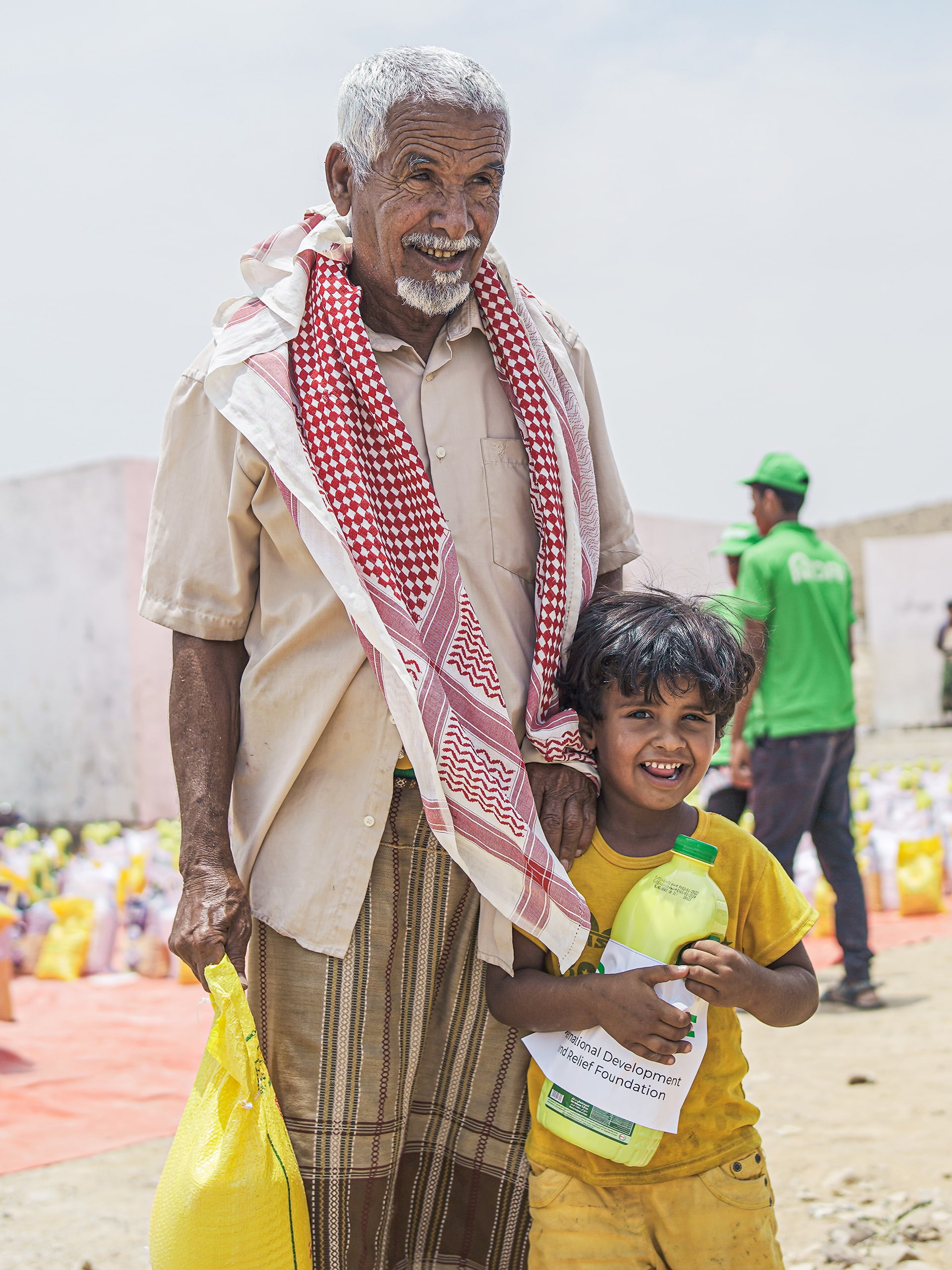A man and a child stand side by side, sharing a moment of connection and warmth.